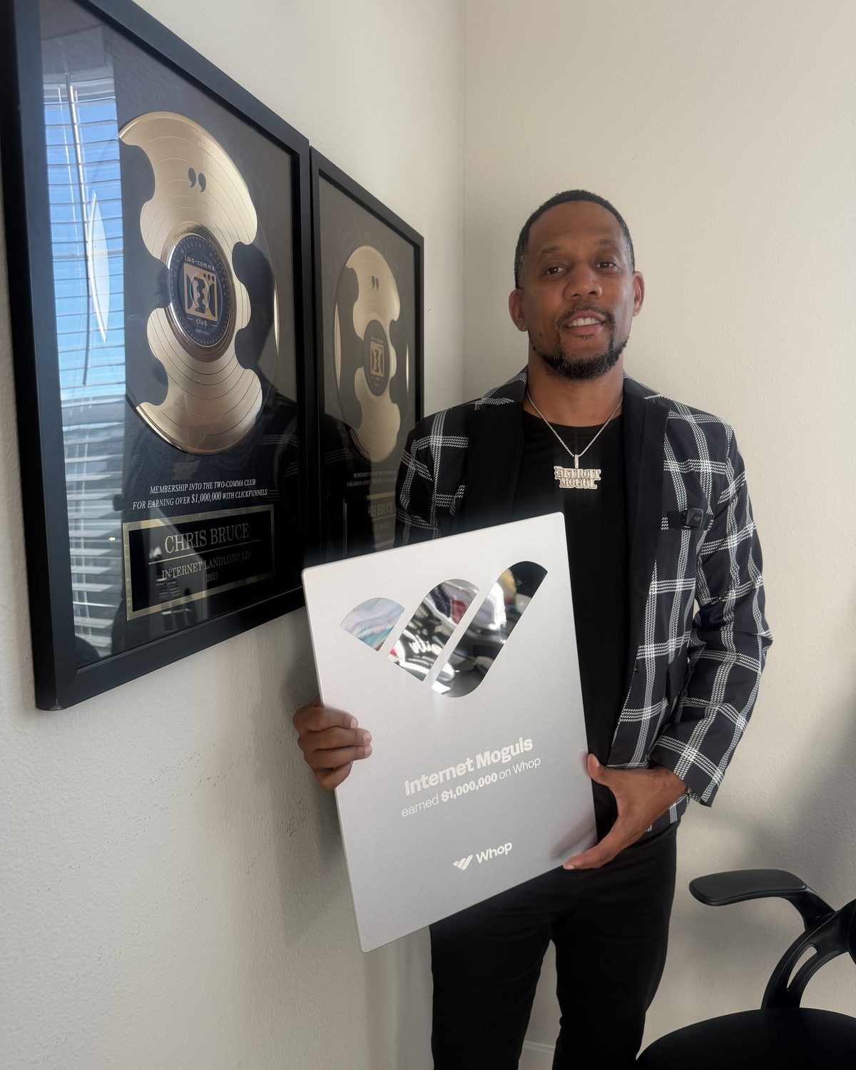 Chris Bruce holding the Whop $1,000,000 plaque in front of his two ClickFunnels Two Comma Club awards